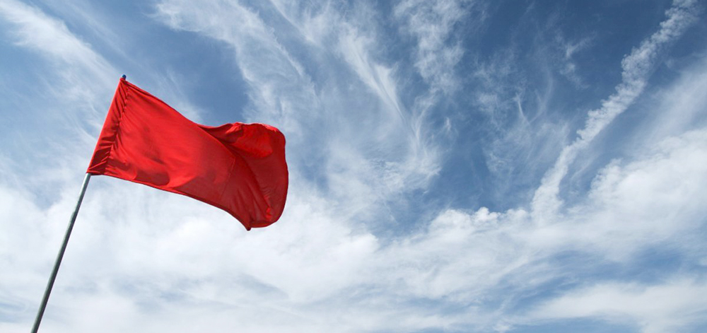 red flag against blue sky