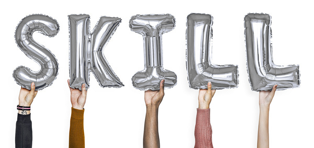 silver balloons that spell out the word "skill"